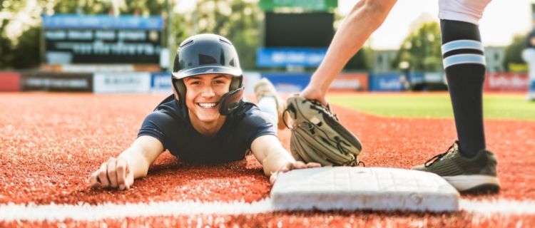 A baseball player slides into a base during a baseball game